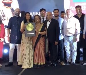 The Prashad team stand on stage at the Bradford Curry Awards holding their award for winning Best Restaurant in Bradford