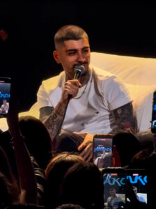 Zayn Malik sat in interview chair with microphone in hand talking about favourite food
